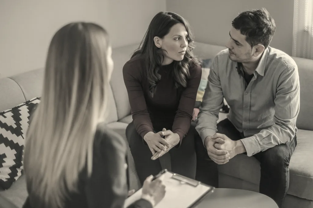 Couple discussing a family estate dispute with a legal adviser