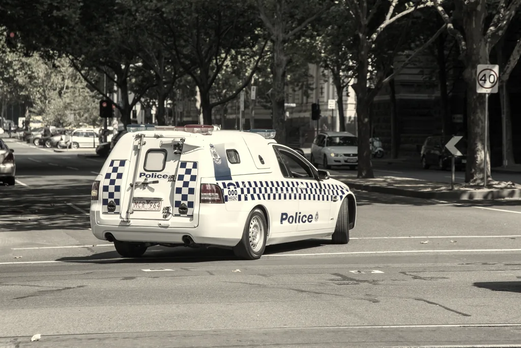 Victoria Police vehicle on a Melbourne road, illustrating criminal and traffic charge matters