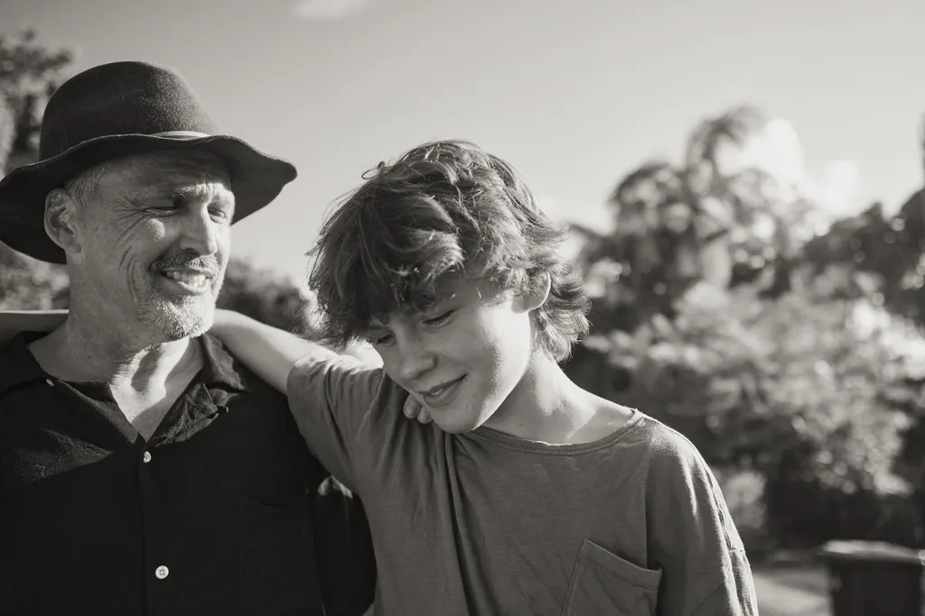Father and teenage son together outdoors, illustrating family relationships and parenting matters